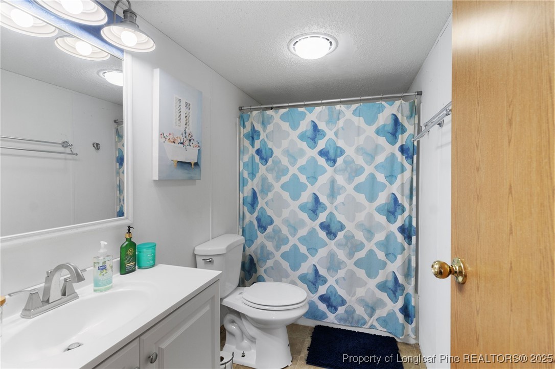 3376 Wade-Stedman Road Wade, NC 28395 - Photo 21 of 35 a bathroom with a sink toilet and shower