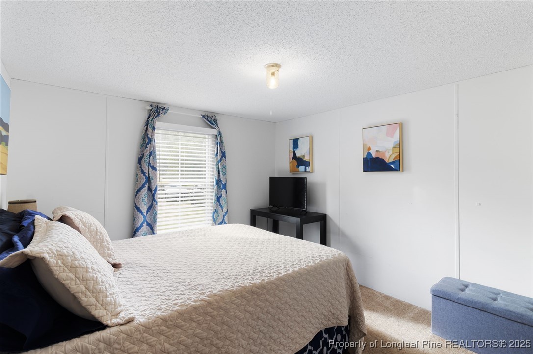 3376 Wade-Stedman Road Wade, NC 28395 - Photo 24 of 35 a bedroom with a bed and a couch