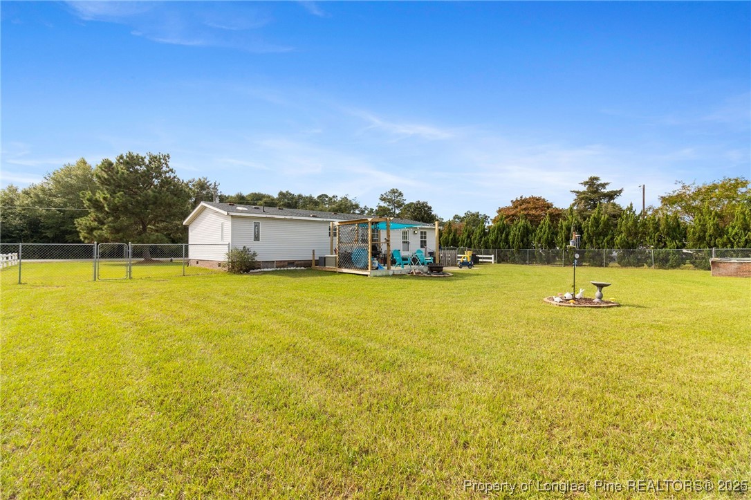 3376 Wade-Stedman Road Wade, NC 28395 - Photo 30 of 35 a view of a swimming pool with an outdoor seating and deck