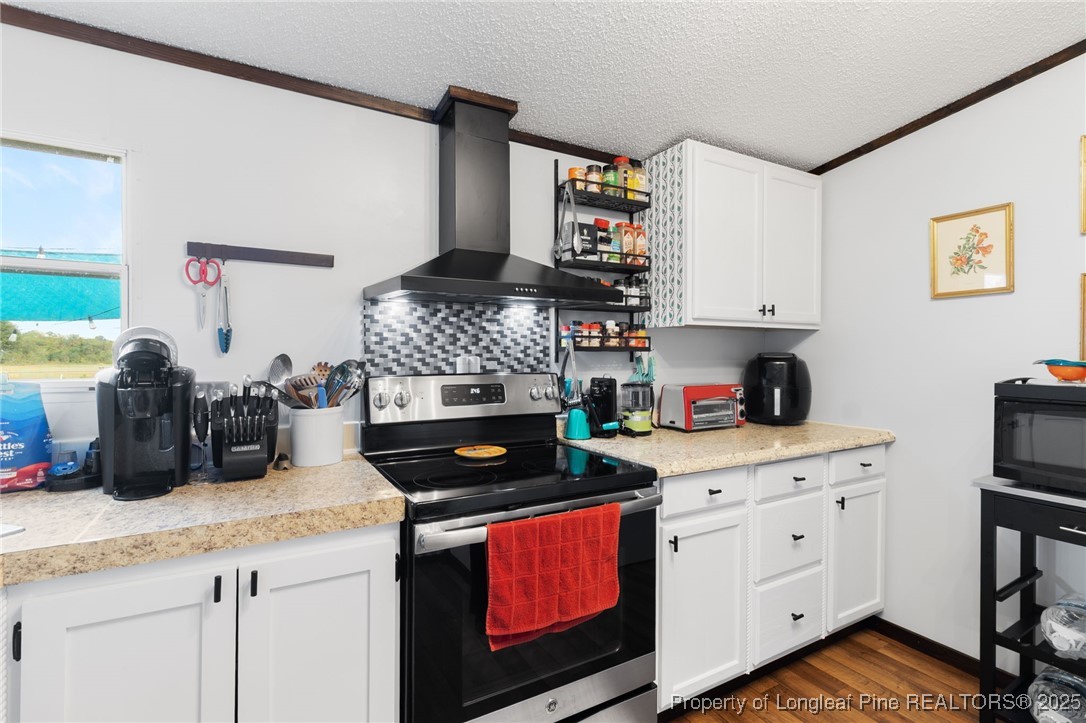 3376 Wade-Stedman Road Wade, NC 28395 - Photo 4 of 35 a kitchen with white cabinets and appliances
