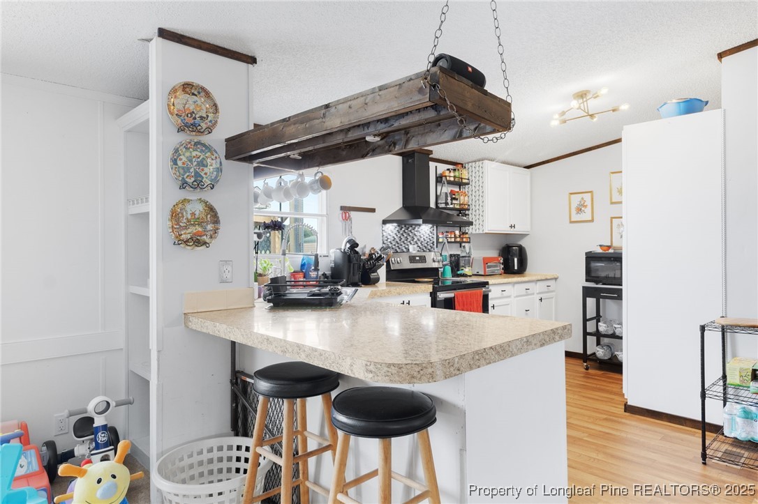 3376 Wade-Stedman Road Wade, NC 28395 - Photo 5 of 35 a kitchen with stainless steel appliances granite countertop a sink and a refrigerator