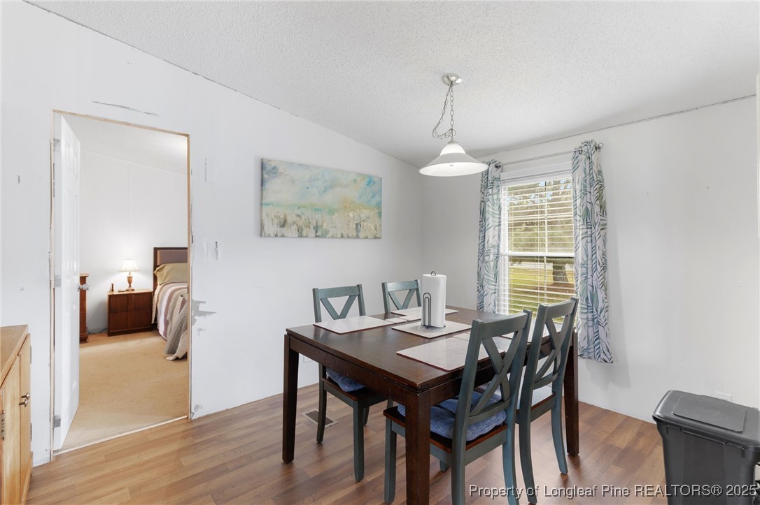 3376 Wade-Stedman Road Wade, NC 28395 - Photo 9 of 35 a view of a dining room with furniture window and wooden floor