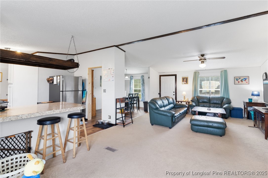 3376 Wade-Stedman Road Wade, NC 28395 - Photo 10 of 35 a living room with furniture and a chandelier