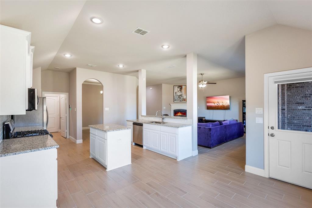 312 Eagle Ridge Road Forney, TX 75126 - Photo 11 of 39 a large white kitchen with cabinets a sink and appliances
