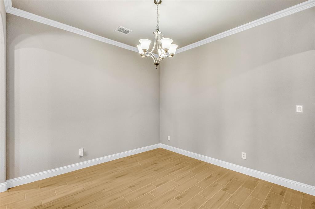 312 Eagle Ridge Road Forney, TX 75126 - Photo 13 of 39 a view of a chandelier fan and wooden floor