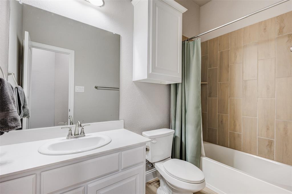 312 Eagle Ridge Road Forney, TX 75126 - Photo 16 of 39 a bathroom with a sink a toilet and shower