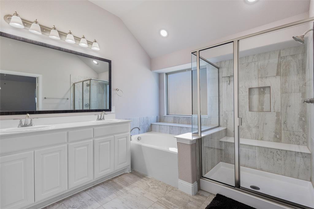312 Eagle Ridge Road Forney, TX 75126 - Photo 21 of 39 a bathroom with a double vanity sink mirror and shower