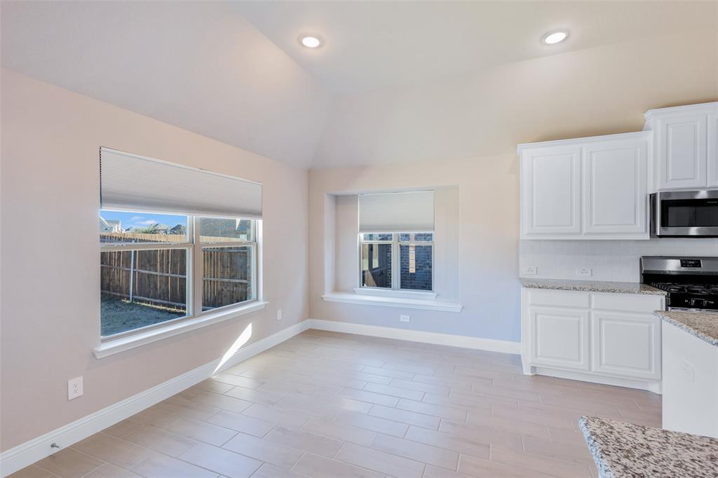 312 Eagle Ridge Road Forney, TX 75126 - Photo 22 of 39 a view of a kitchen with a sink a fireplace and a window