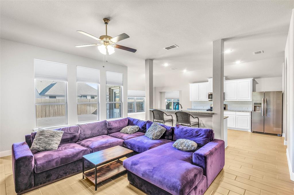 312 Eagle Ridge Road Forney, TX 75126 - Photo 6 of 39 a living room with furniture and a view of kitchen
