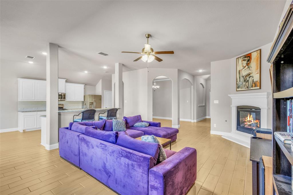312 Eagle Ridge Road Forney, TX 75126 - Photo 8 of 39 a living room with furniture fireplace and kitchen view
