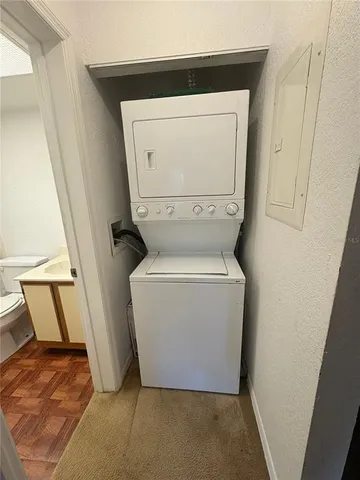 a utility room with a toilet and a sink