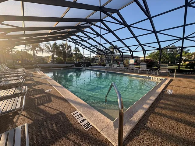 a swimming pool with outdoor seating