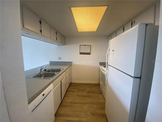 a kitchen with a refrigerator a sink and dishwasher