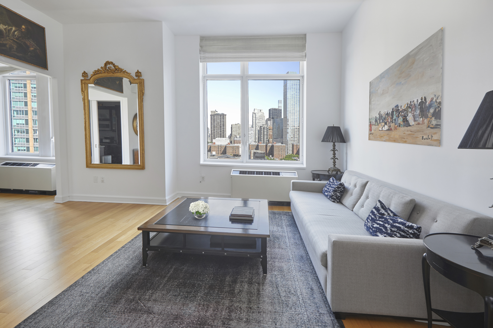 80 Riverside Boulevard, Unit 19B Manhattan, NY 10069 - Photo 4 of 18 a living room with furniture and window