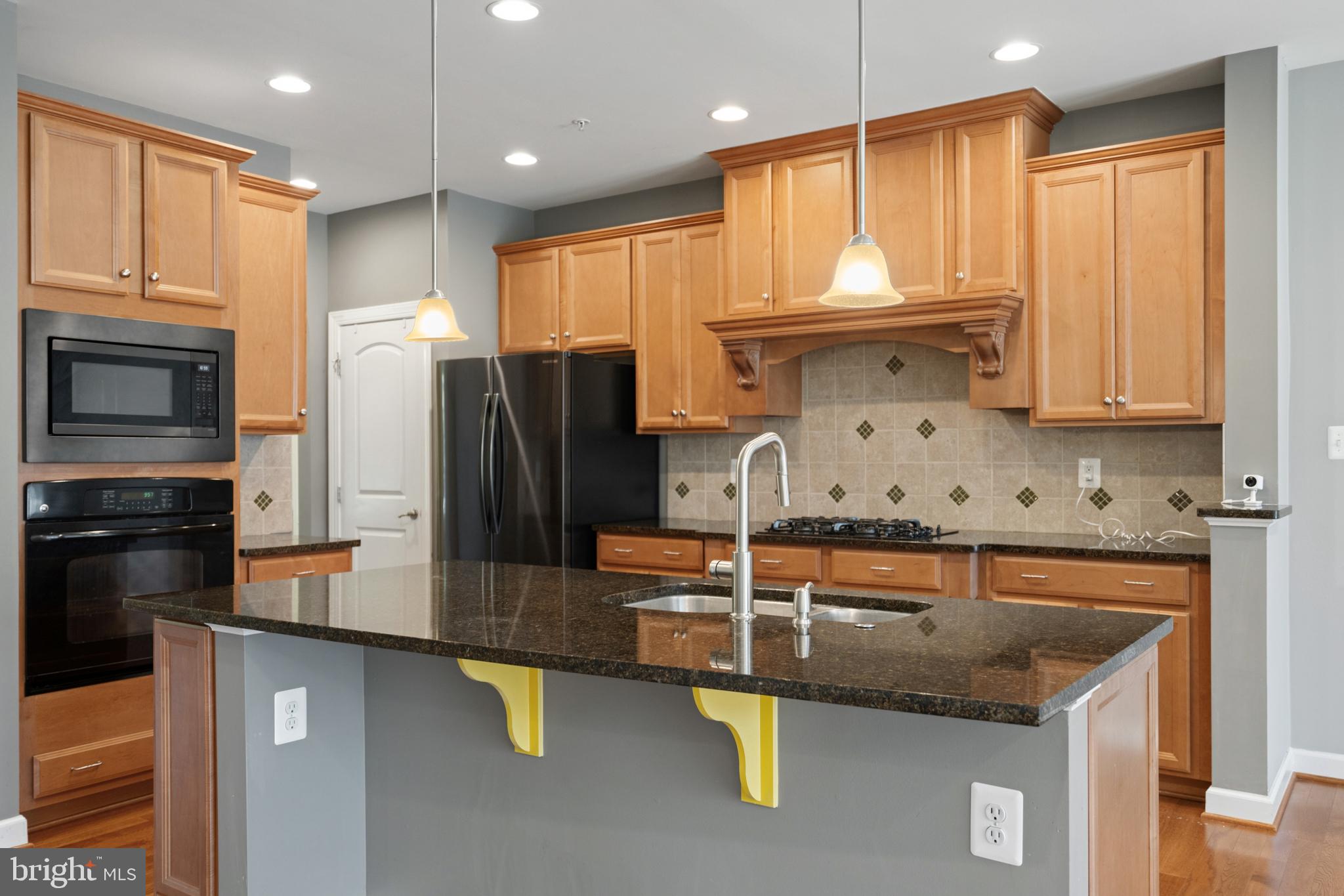 493 Watkins Mill Road Gaithersburg, MD 20878 - Photo 22 of 59 Modern kitchen with warm wood tones.
