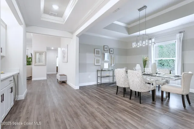 a view of a dining room with furniture and wooden floor