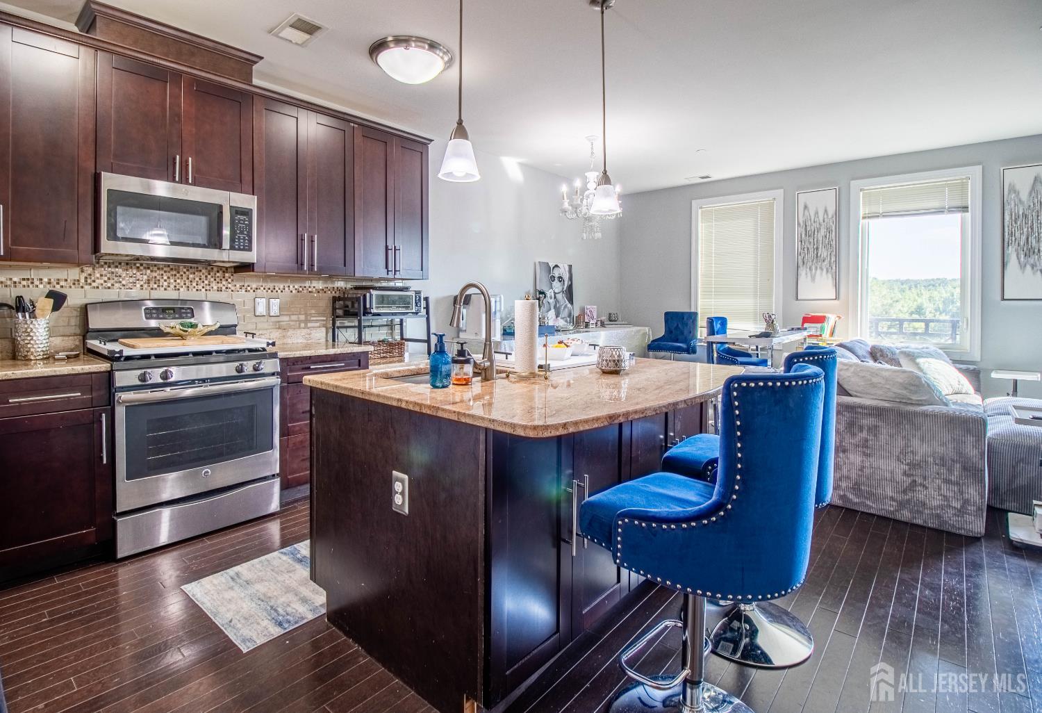 a kitchen with a sink dining table and chairs