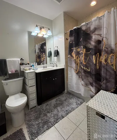 a bathroom with a sink vanity and mirror