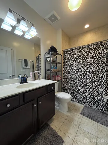 a bathroom with a sink vanity and mirror
