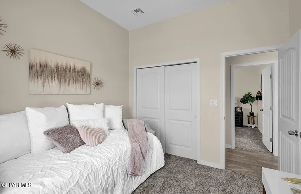 a bedroom with a bed and a potted plant