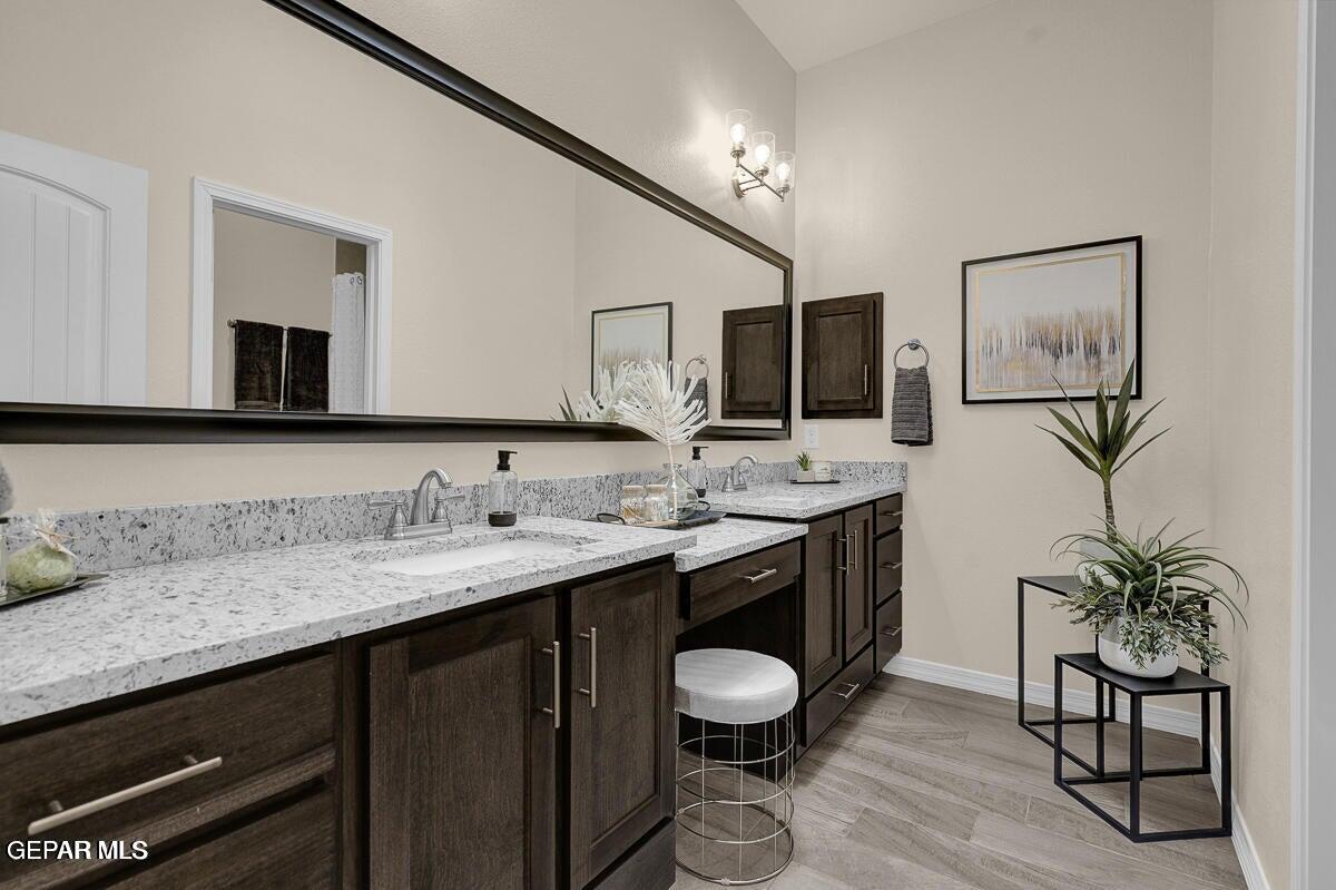 6923 Levee Circle Anthony, NM 88021 - Photo 26 of 44 a spacious bathroom with a granite countertop sink a mirror and a