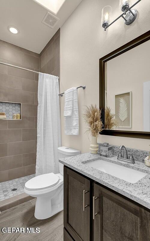 6923 Levee Circle Anthony, NM 88021 - Photo 34 of 44 a bathroom with a granite countertop sink toilet a mirror and shower