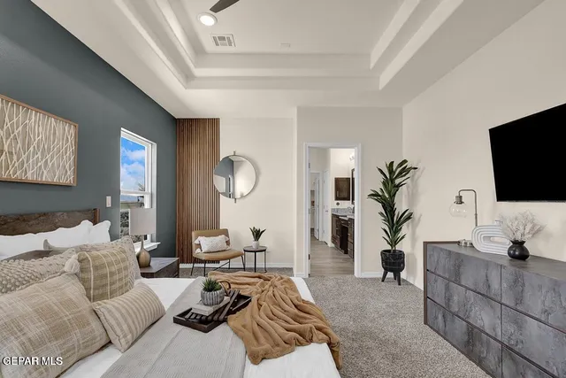 a bathroom with double vanity and a mirror