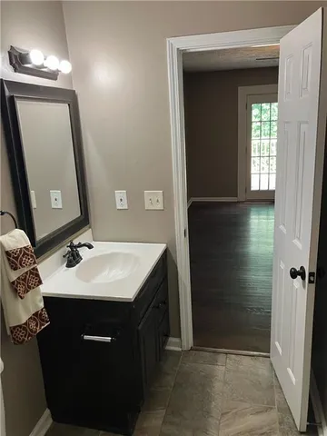a bathroom with a sink a toilet and mirror