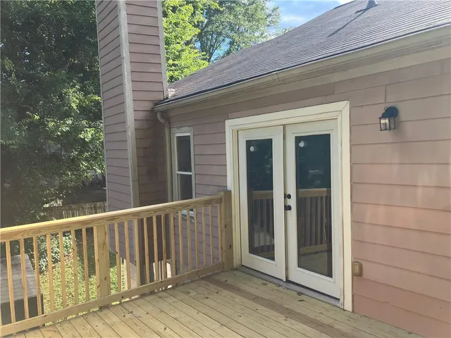 a view of a balcony with wooden floor