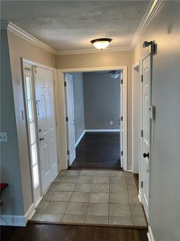 wooden floor with view of bathroom with mirror