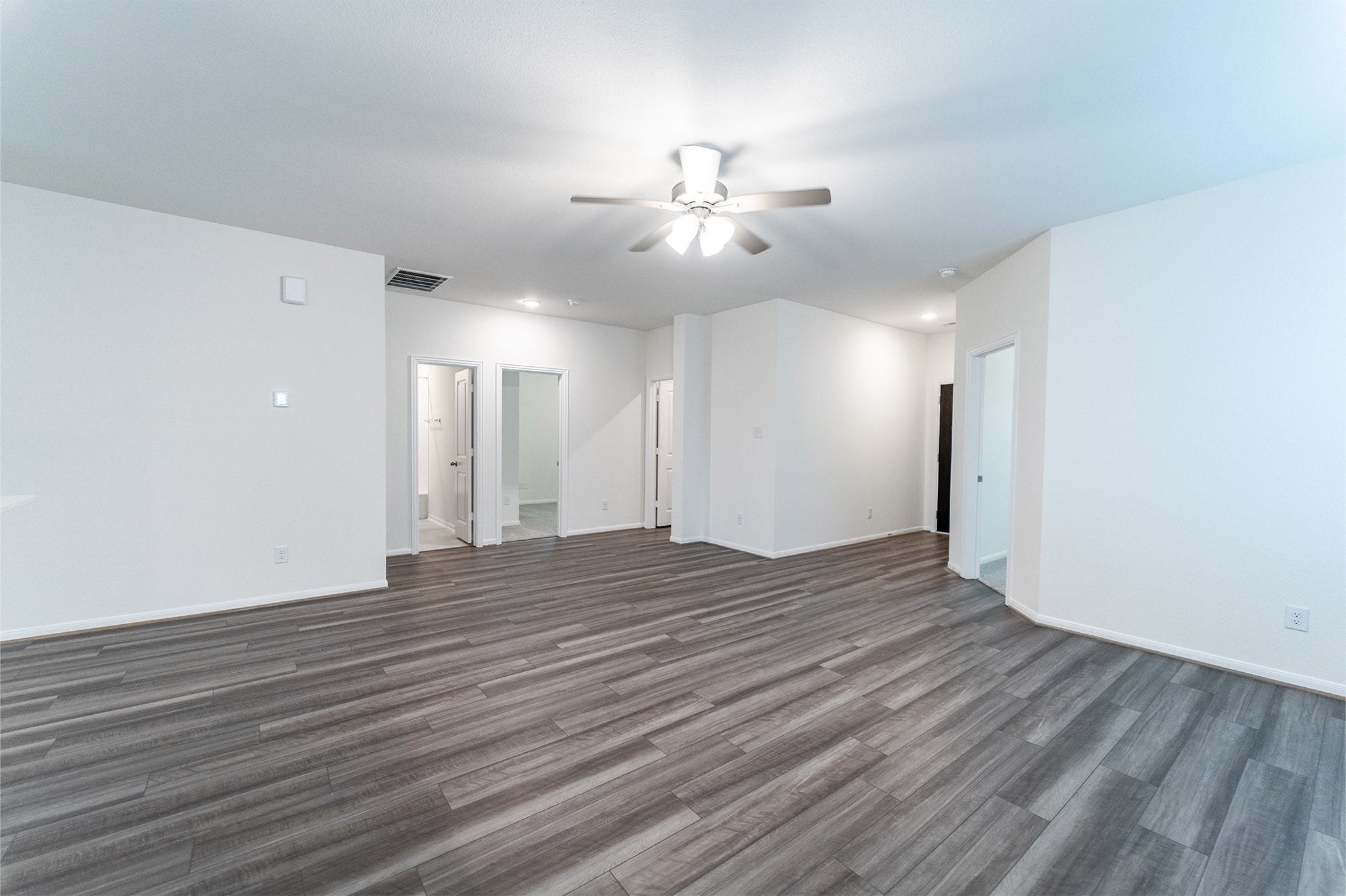 3527 Prairie Rose Trail Angleton, TX 77515 - Photo 5 of 19 a view of an empty room with wooden floor and a ceiling fan