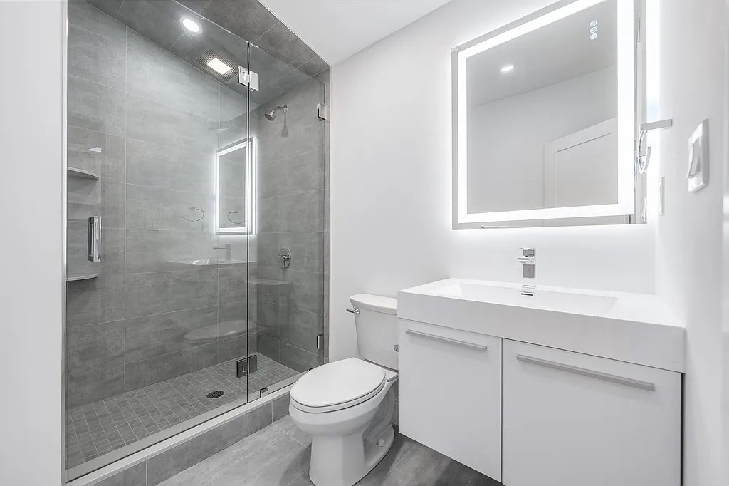 536 Broadway, Unit 204 Everett, MA 02149 - Photo 6 of 7 a bathroom with a sink a toilet and shower