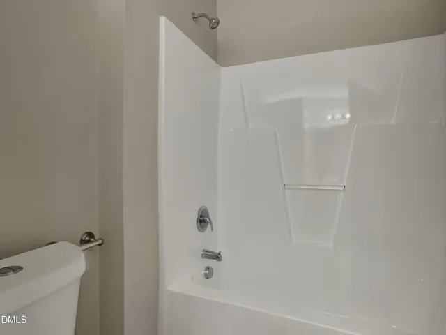 a bathroom with a bathtub and a toilet
