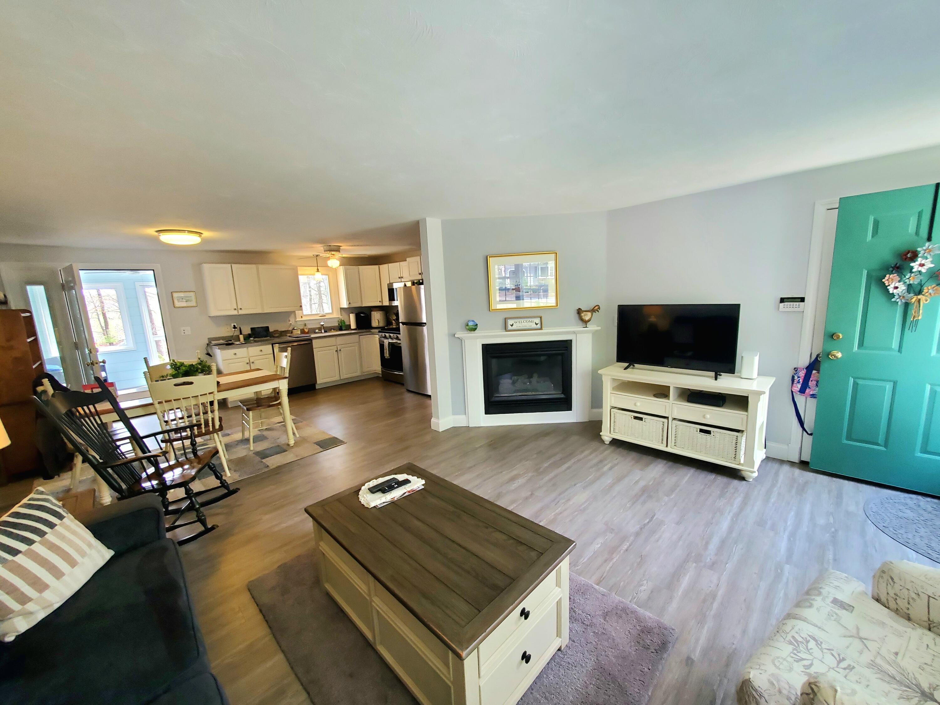 52 Thayer Road Dennis, MA 02660 - Photo 4 of 19 a living room with furniture and a fireplace