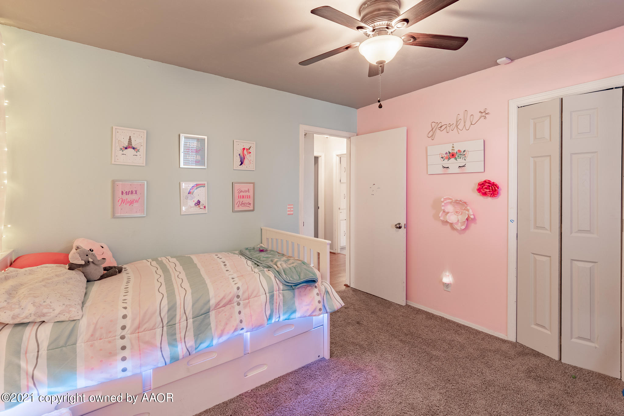 7306 Imperial Drive Amarillo, TX 79121 - Photo 12 of 24 a bedroom with a bed and a chandelier