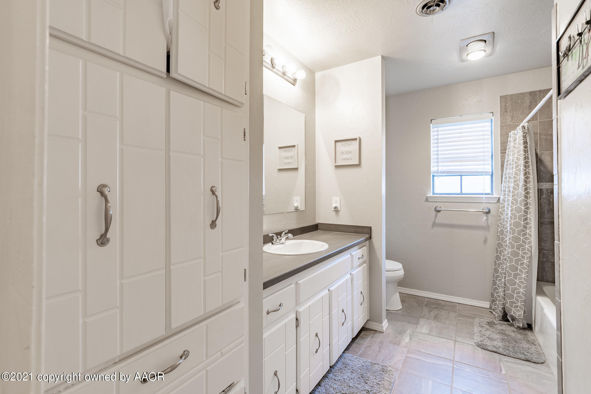 7306 Imperial Drive Amarillo, TX 79121 - Photo 13 of 24 a bathroom with a granite countertop sink a mirror and a shower