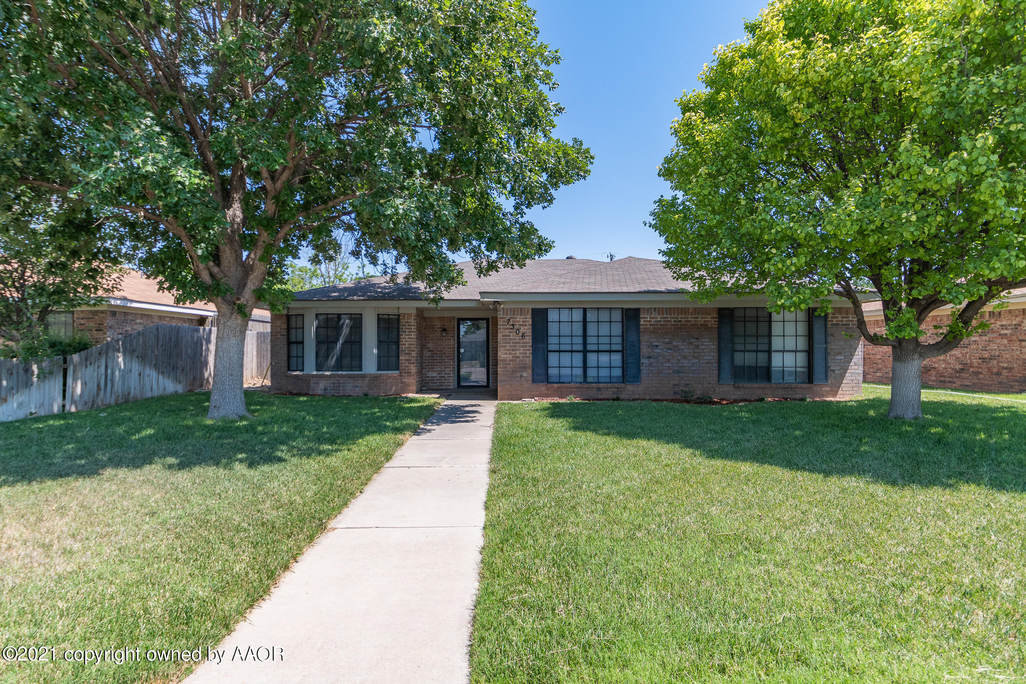 7306 Imperial Drive Amarillo, TX 79121 - Photo 2 of 24 front view of a house with a yard