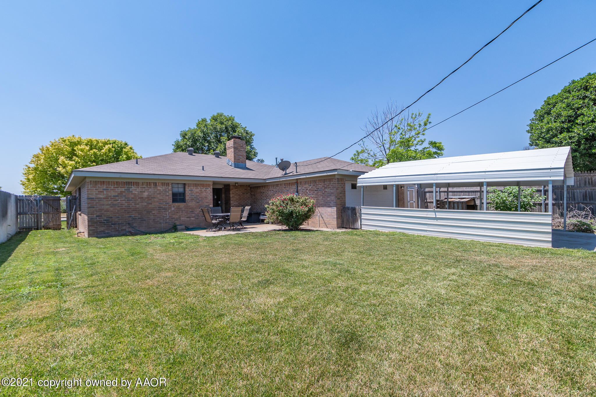 7306 Imperial Drive Amarillo, TX 79121 - Photo 22 of 24 a front view of a house with a garden
