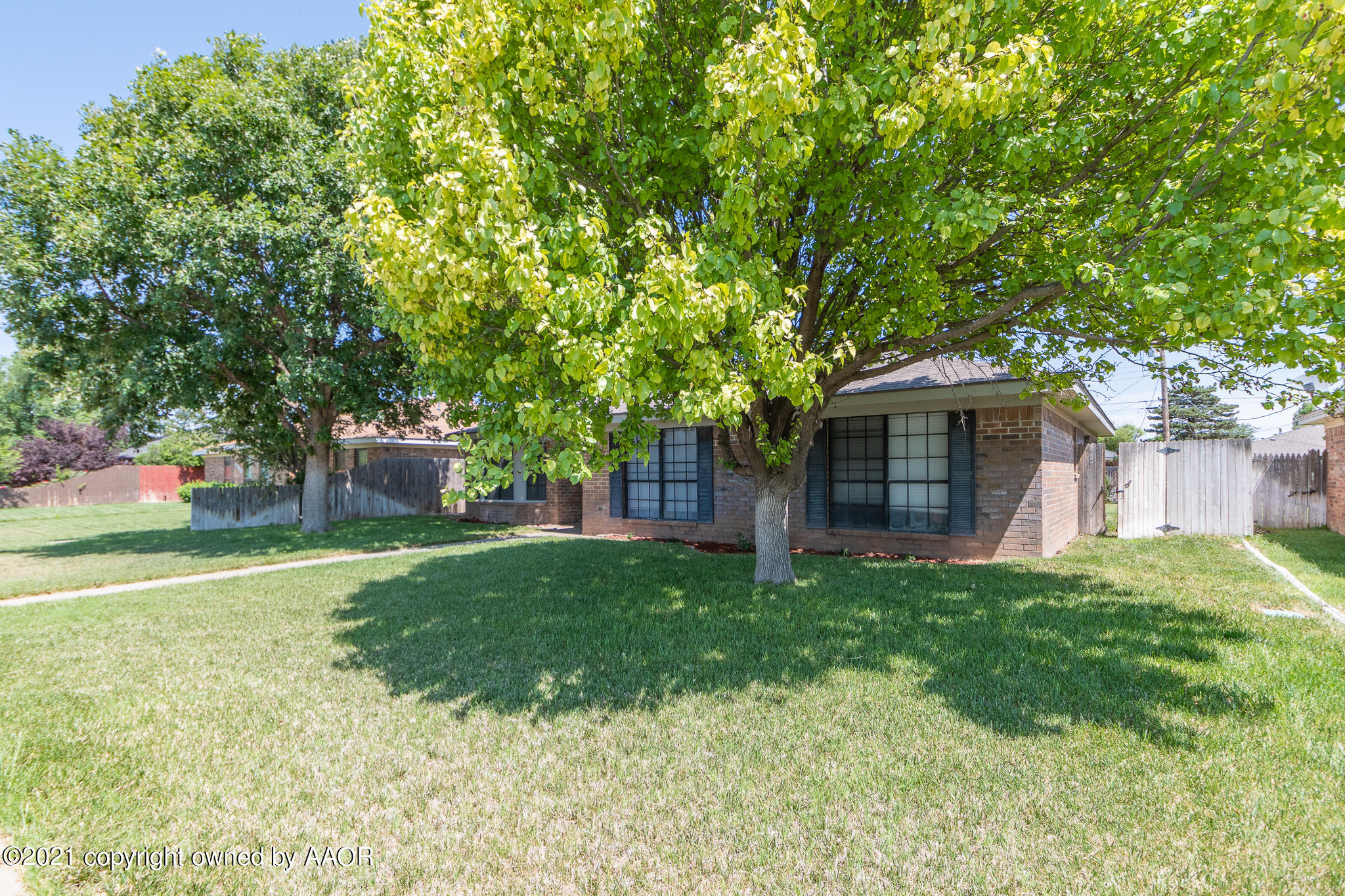 7306 Imperial Drive Amarillo, TX 79121 - Photo 3 of 24 a front view of a house with a garden