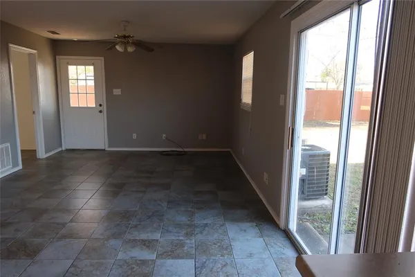 a view of an empty room with windows