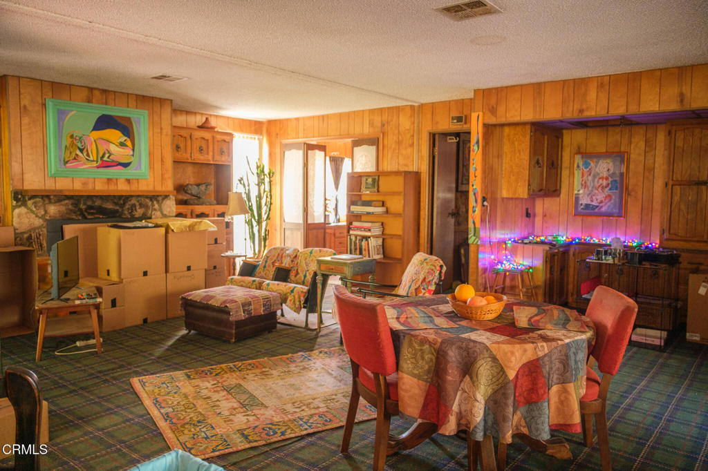 8624 Nye Road Ventura, CA 93001 - Photo 20 of 39 a living room with furniture a rug and a large window