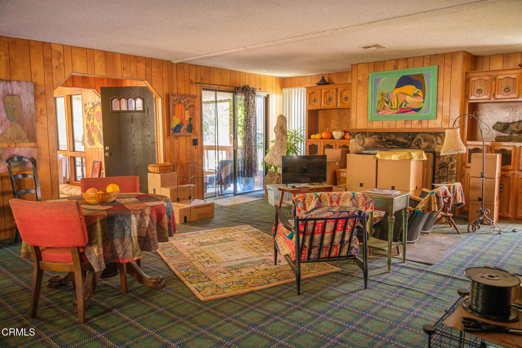 8624 Nye Road Ventura, CA 93001 - Photo 21 of 39 a living room with furniture and a floor to ceiling window