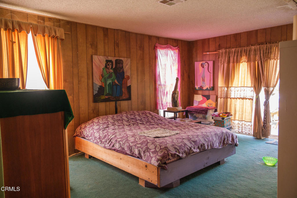 8624 Nye Road Ventura, CA 93001 - Photo 24 of 39 a bedroom with a bed and a window