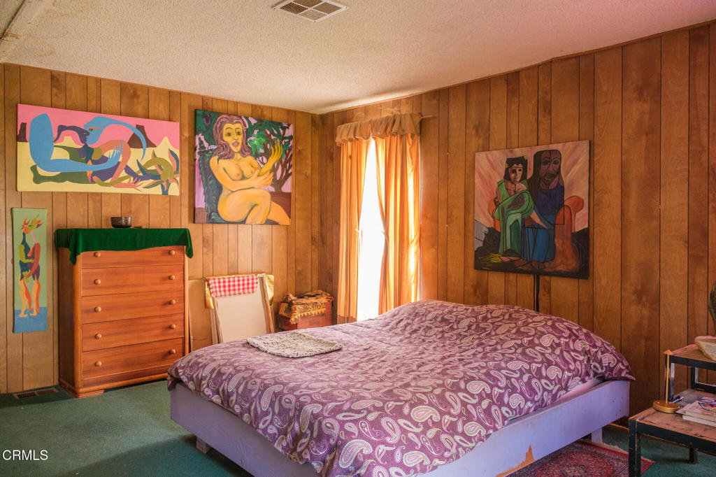 8624 Nye Road Ventura, CA 93001 - Photo 25 of 39 a bedroom with a bed and a cabinet