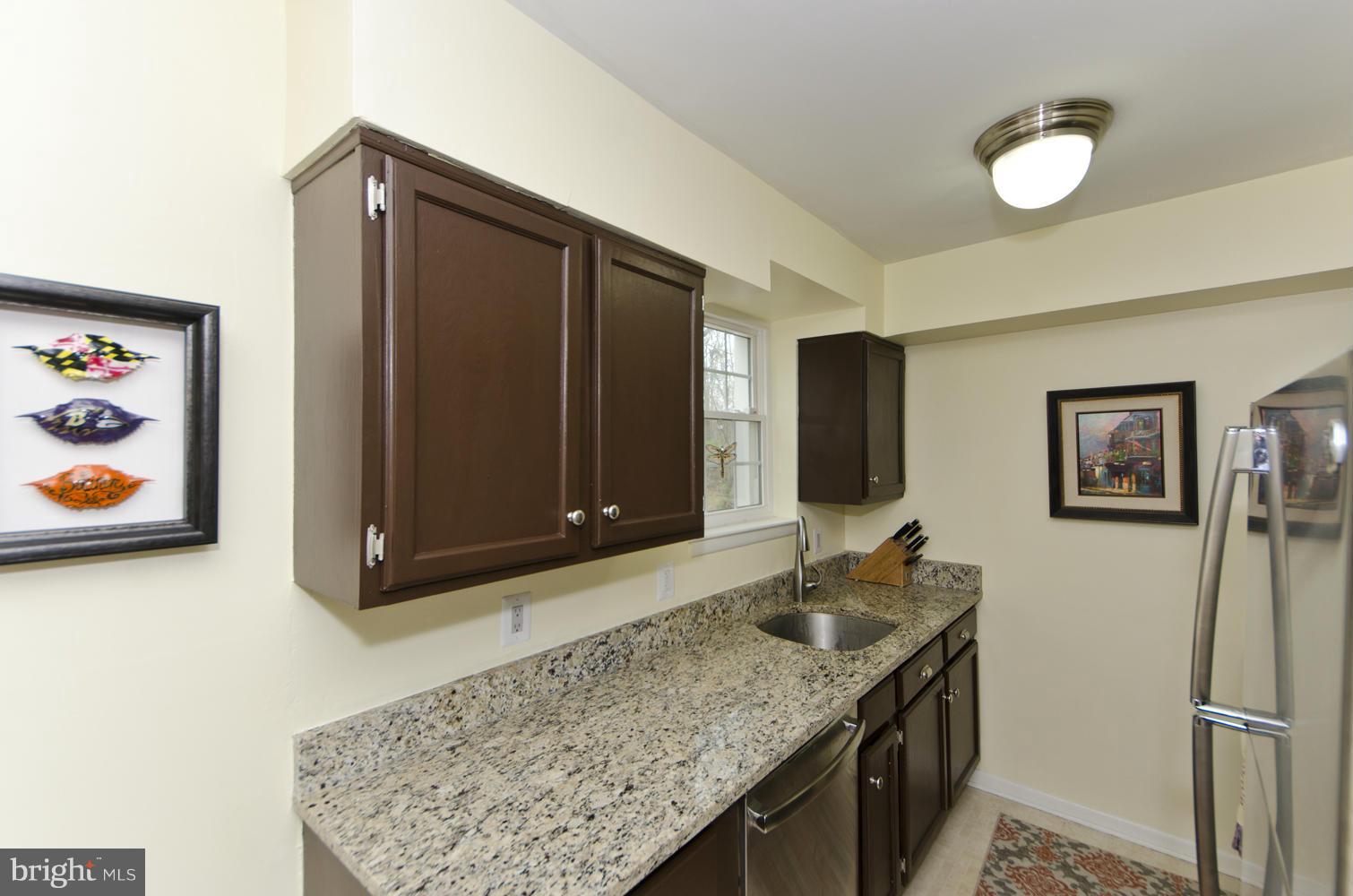 4647 28th Road South, Unit B Arlington, VA 22206 - Photo 6 of 20 a bathroom with a granite countertop sink and a mirror