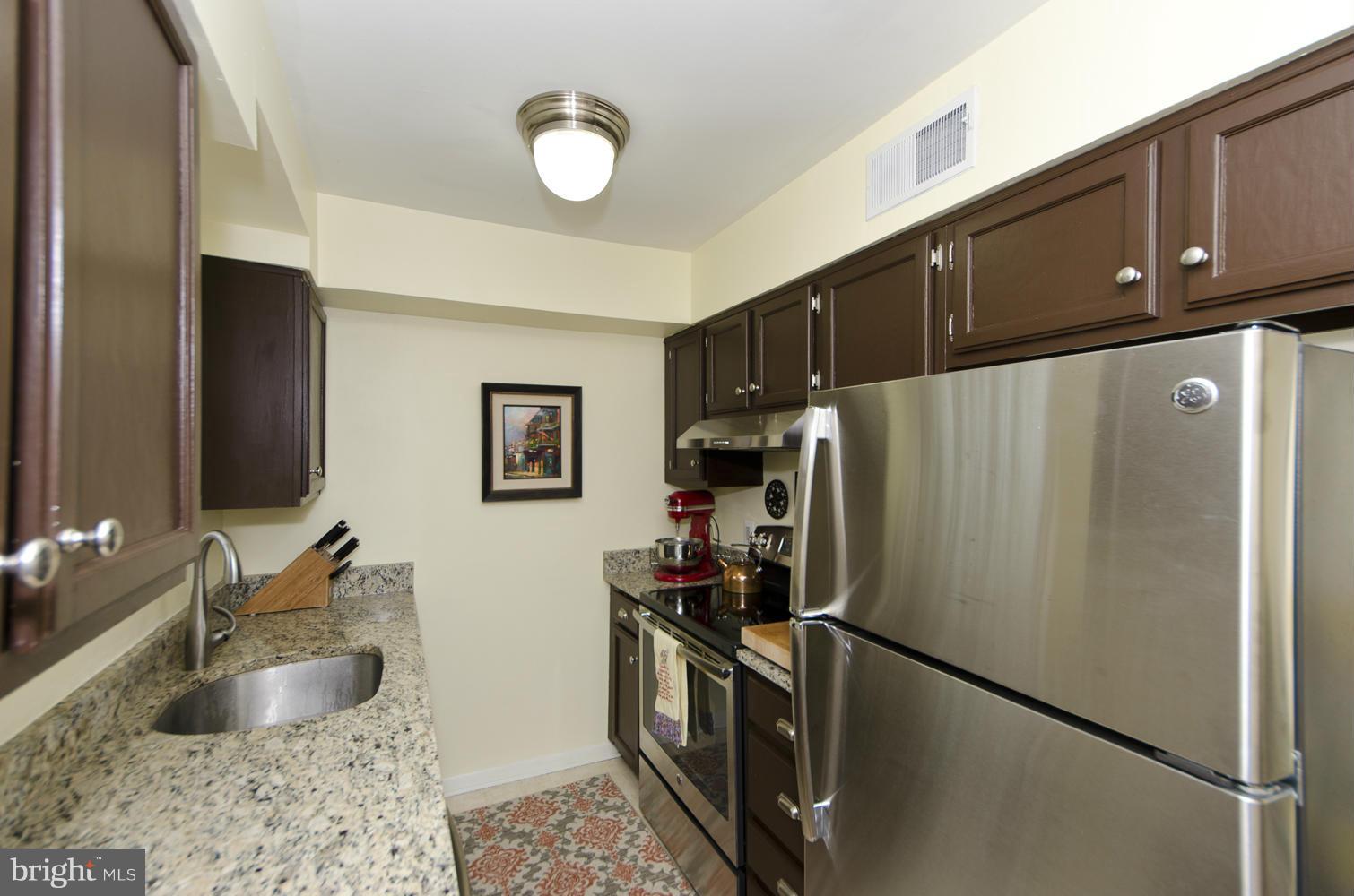 4647 28th Road South, Unit B Arlington, VA 22206 - Photo 7 of 20 a kitchen with stainless steel appliances granite countertop a refrigerator a sink and a stove