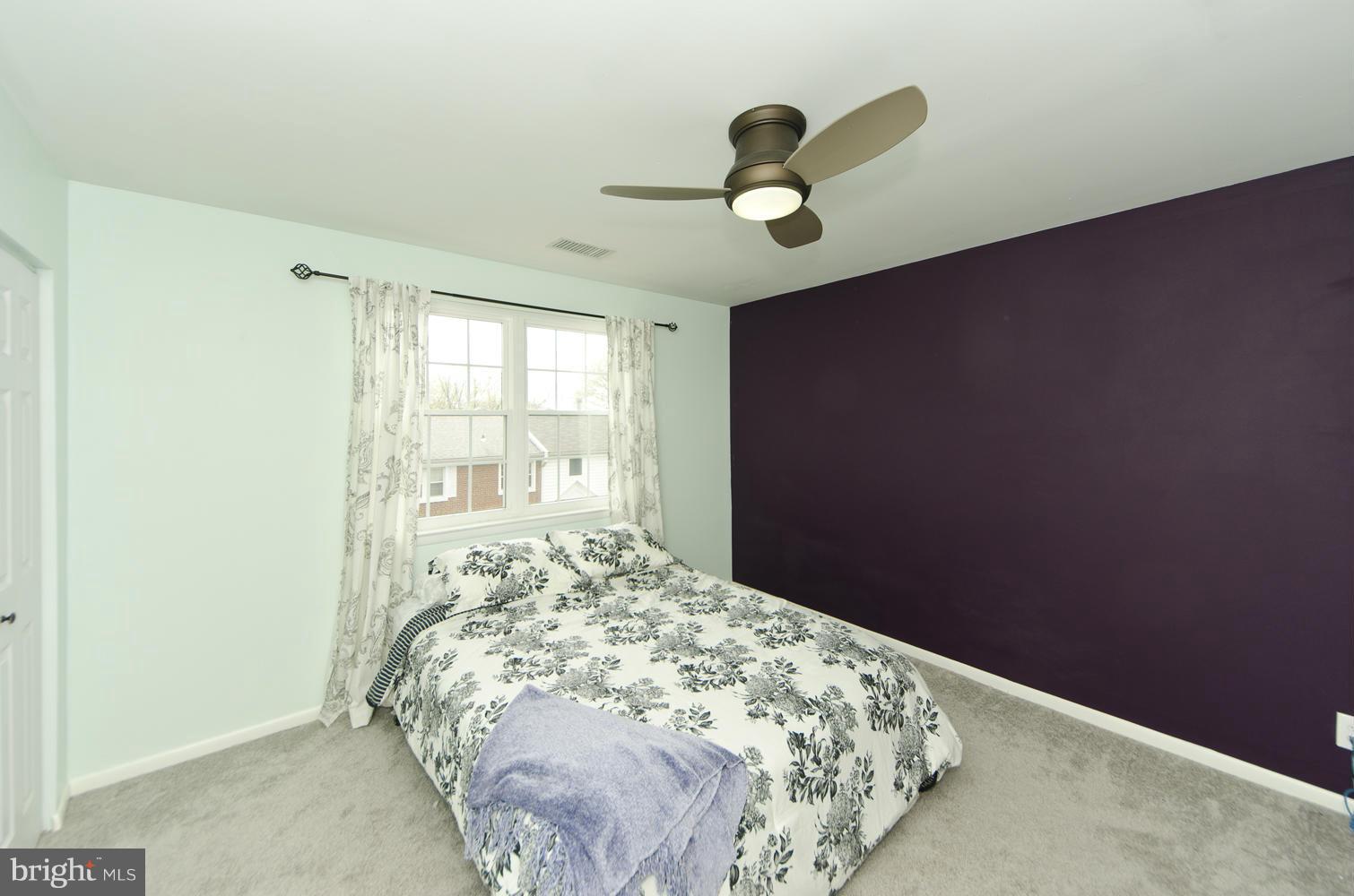 4647 28th Road South, Unit B Arlington, VA 22206 - Photo 9 of 20 a bed sitting in a bedroom next to a window