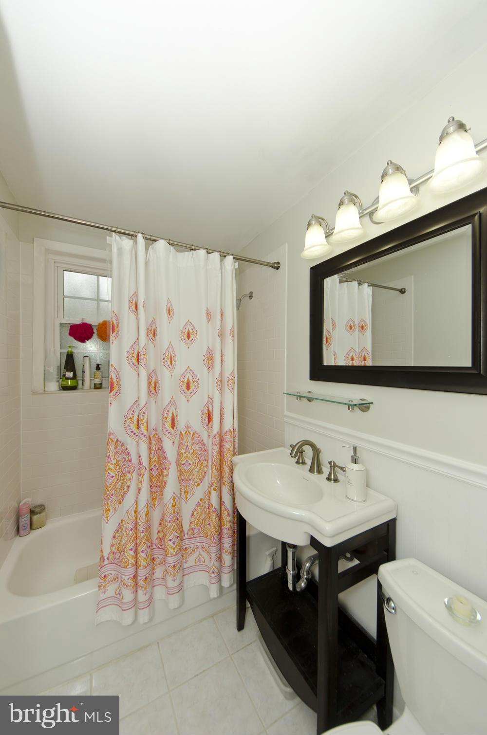 4647 28th Road South, Unit B Arlington, VA 22206 - Photo 10 of 20 a bathroom with a sink a toilet and a mirror
