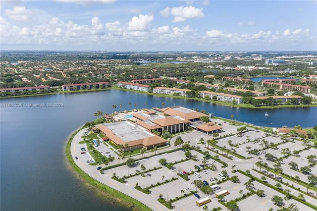 an aerial view of a house with a lake