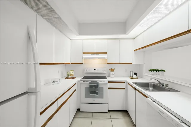 a kitchen with white cabinets stainless steel appliances and sink